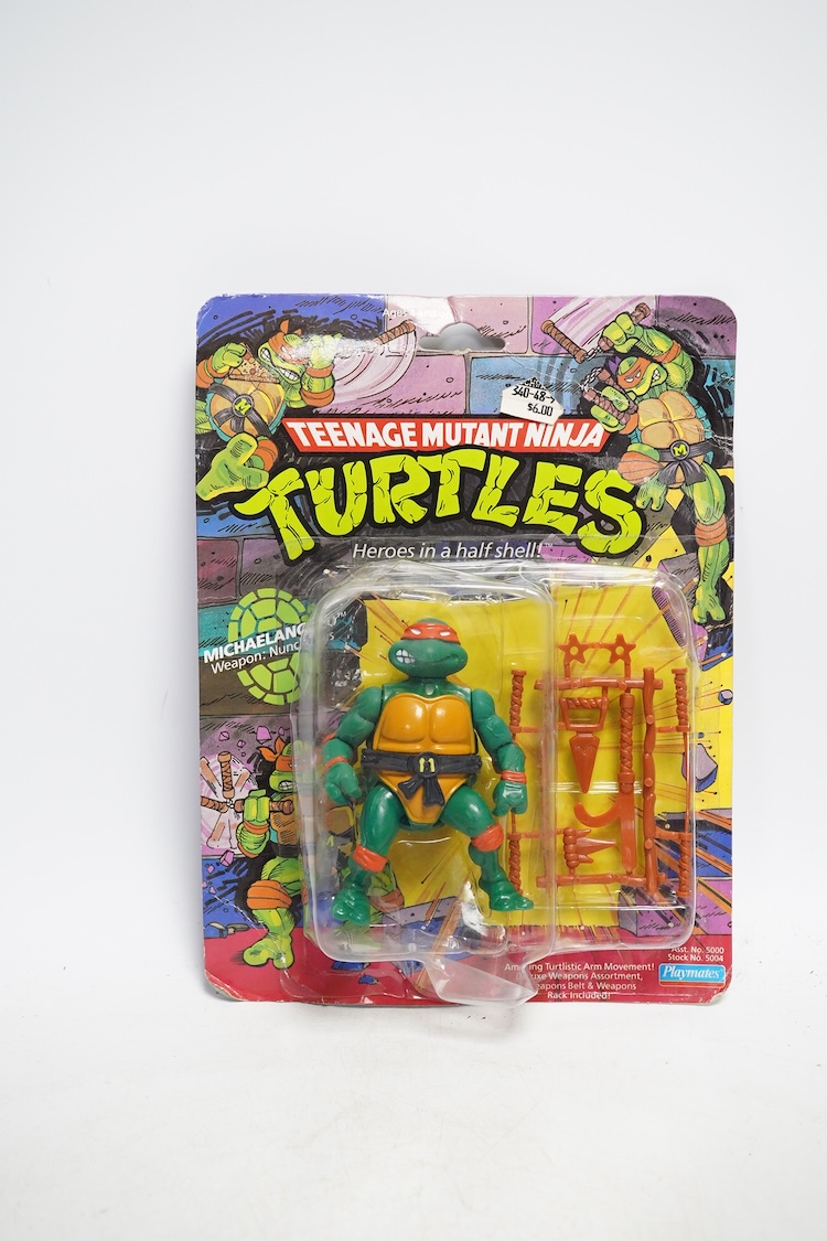 A Playmates Teenage Mutant Ninja Turtles figure of Michaelangelo, dated 1988, a Teenage Mutant Hero Turtles packeted ‘Teasers’, dated 1990, and a Matchbox Ring Raiders toy. Condition - fair to good, some creases to backi